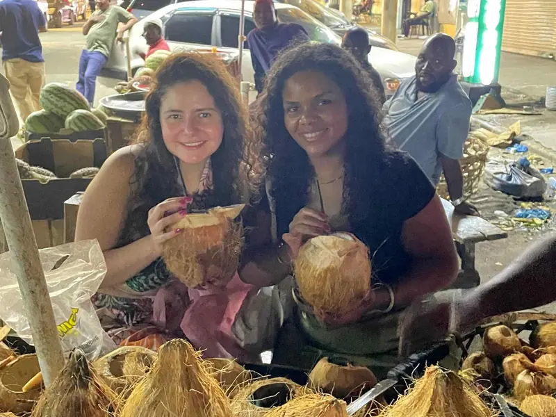 Guests drinking fresh coconut water on a food tour